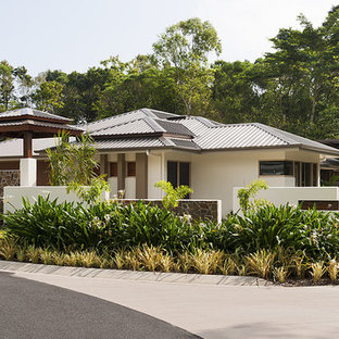 Asian white house exterior in Cairns with a hip roof and a metal roof.