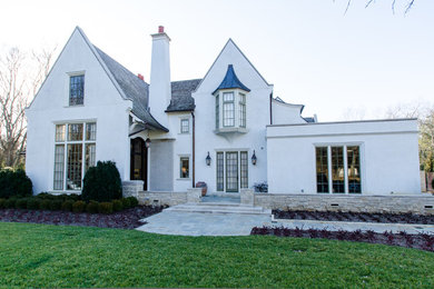 Inspiration for a large timeless white three-story stucco gable roof remodel in Nashville