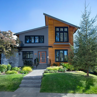 Example of a trendy two-story exterior home design in Vancouver with a shed roof