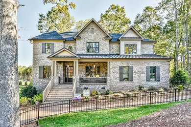 Inspiration for a large transitional brown two-story brick exterior home remodel in Charlotte