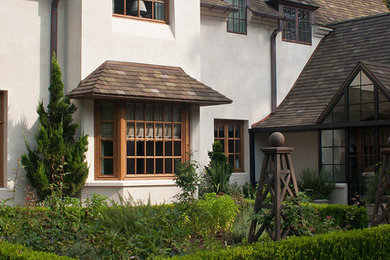 Пример оригинального дизайна: белый частный загородный дом в классическом стиле с черепичной крышей