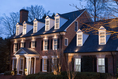 Inspiration for a large timeless red three-story brick gable roof remodel in Atlanta