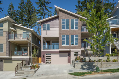 Example of a trendy multicolored three-story house exterior design in Vancouver
