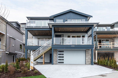 Inspiration for a large contemporary blue three-story house exterior remodel in Vancouver