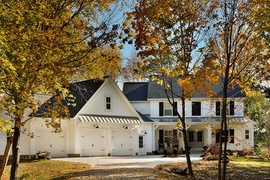 Farmhouse white two-story vinyl exterior home photo in Cleveland