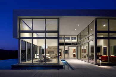 Inspiration for a mid-sized contemporary white one-story glass flat roof remodel in Austin