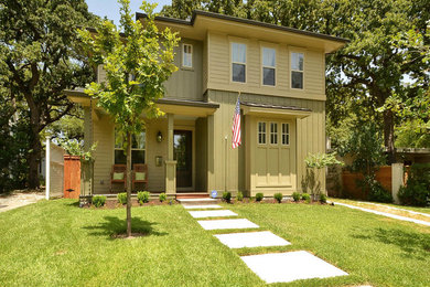 Transitional green two-story concrete fiberboard exterior home idea in Austin with a shed roof