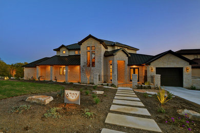 Inspiration for a large transitional white two-story stone exterior home remodel in Austin with a hip roof
