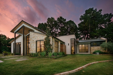 Transitional multicolored one-story stone exterior home idea in Houston with a metal roof