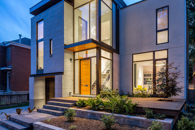 Contemporary gray two-story stone exterior home idea in Ottawa