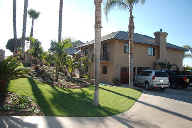 Example of a mid-sized classic beige two-story stucco exterior home design in San Diego with a shingle roof