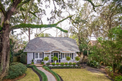 Design ideas for a small traditional two floor house exterior in Jacksonville with a half-hip roof.