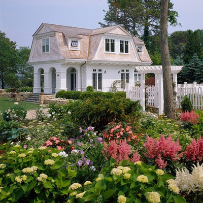 Mid-sized ornate white two-story wood exterior home photo in Boston with a gambrel roof