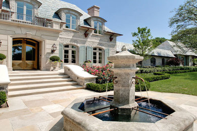Example of a mid-sized classic white two-story stone house exterior design in Dallas with a shed roof and a shingle roof