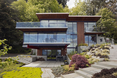 Inspiration for a mid-sized contemporary brown three-story wood exterior home remodel in Seattle with a metal roof