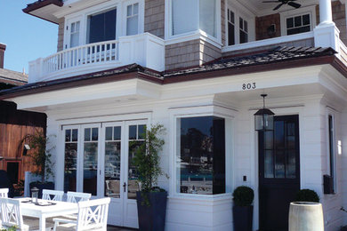 Elegant white two-story mixed siding exterior home photo in Orange County