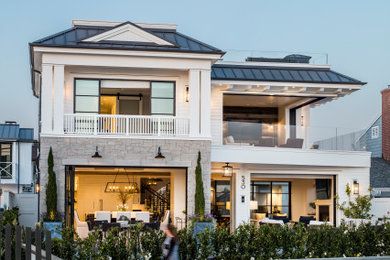 Inspiration for a coastal three-story exterior home remodel in Orange County