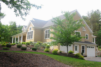 Example of a large transitional yellow two-story concrete fiberboard exterior home design in Boston