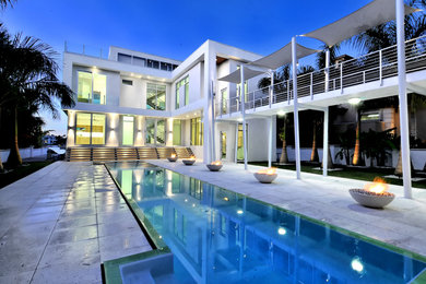 Inspiration for a large modern white two-story stucco exterior home remodel in Tampa