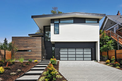 Inspiration for a large modern white two-story mixed siding exterior home remodel in Seattle