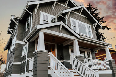 Example of a mid-sized arts and crafts brown two-story wood house exterior design in Seattle with a hip roof and a shingle roof