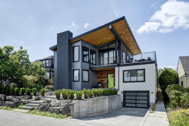 Example of a trendy multicolored house exterior design in Seattle with a shed roof