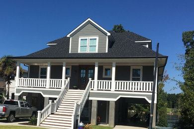 Mid-sized beach style gray two-story wood house exterior photo in Other with a hip roof and a shingle roof