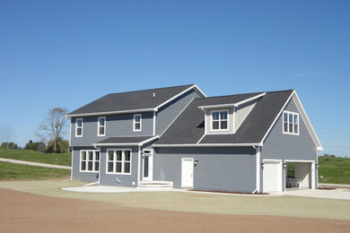 Large gray two-story vinyl exterior home photo in Milwaukee