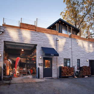 Large industrial white two-story brick flat roof idea in Columbus