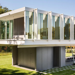 Inspiration for a large modern white two-story metal exterior home remodel in New York with a green roof