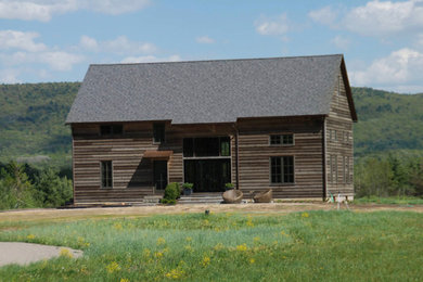 Example of a mid-sized minimalist two-story wood house exterior design with a shingle roof