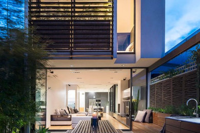Large contemporary two-story mixed siding flat roof idea in Melbourne