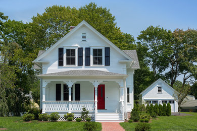 Example of a mid-sized cottage white two-story concrete fiberboard exterior home design in Providence with a shingle roof