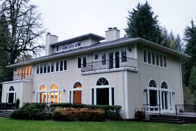 Large beige two-story concrete fiberboard house exterior idea in Portland with a hip roof and a shingle roof