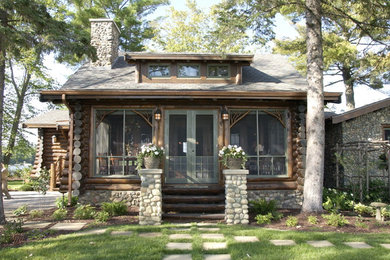 Design ideas for a brown rustic bungalow house exterior in Minneapolis with wood cladding and a pitched roof.