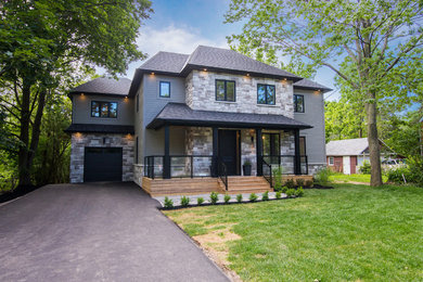 Mid-sized arts and crafts gray two-story mixed siding house exterior photo in Toronto with a hip roof and a shingle roof