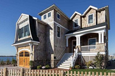 Inspiration for a mid-sized coastal beige two-story wood exterior home remodel in Philadelphia