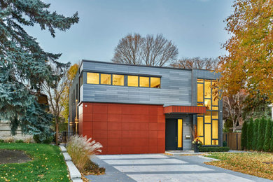 Example of a large minimalist gray three-story stone exterior home design in Toronto with a mixed material roof