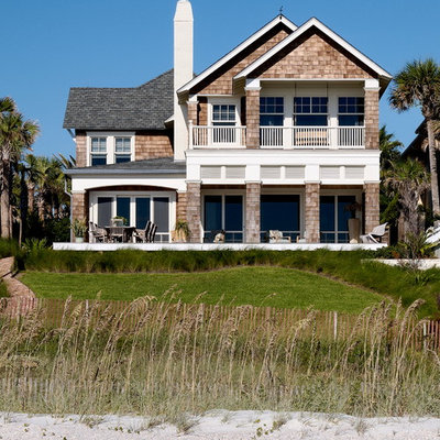Example of a beach style two-story wood gable roof design in Jacksonville