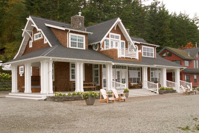 Example of a mid-sized beach style brown two-story wood exterior home design in Seattle
