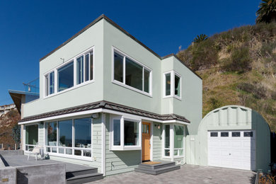 Inspiration for a small coastal gray two-story mixed siding flat roof remodel in Other