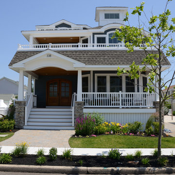 Beach house front elevation features double front doors