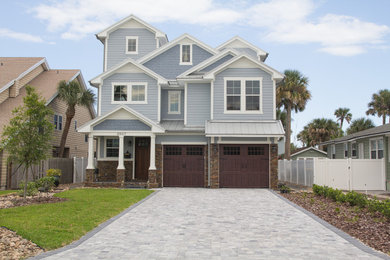 Inspiration for a coastal three-story mixed siding exterior home remodel in Jacksonville with a metal roof