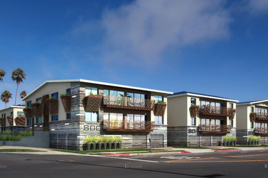 This is an example of a beige contemporary two floor house exterior in Los Angeles with wood cladding.