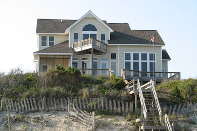 Inspiration for a large timeless beige two-story vinyl exterior home remodel in Other