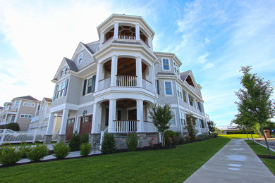 Large coastal white three-story wood exterior home idea in Philadelphia with a shingle roof