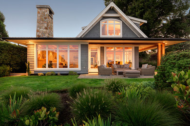 Transitional beige two-story wood exterior home photo in Other with a shingle roof