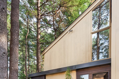 Trendy beige two-story wood exterior home photo in Boston