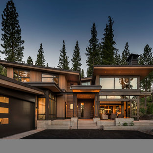 Example of a mountain style brown two-story wood house exterior design in Other with a shed roof