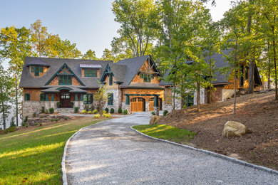 Example of a large mountain style green three-story wood exterior home design in Charlotte with a mixed material roof